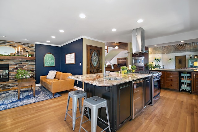 1444 Guildford Dr, Bourbonnais, IL 60914 - kitchen with wine cooler, appliances with stainless steel finishes, island range hood, a kitchen breakfast bar, and light wood-style floors