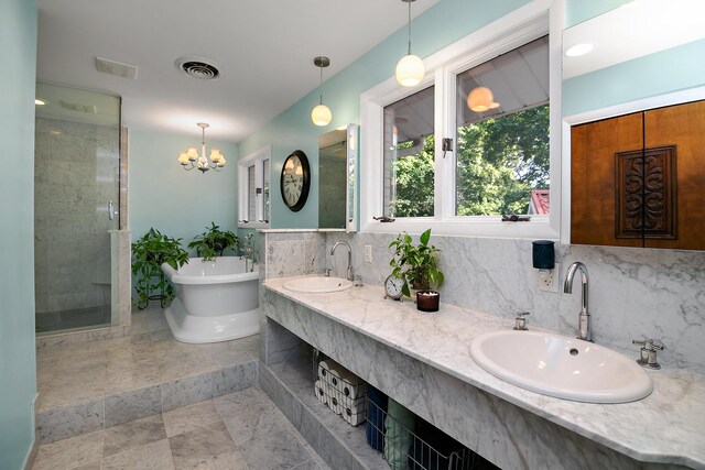 1444 Guildford Dr, Bourbonnais, IL 60914 - full bathroom with a soaking tub, double vanity, a shower stall, and a chandelier