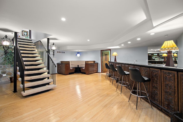 1444 Guildford Dr, Bourbonnais, IL 60914 - indoor wet bar featuring stairs, recessed lighting, and light wood-style floors