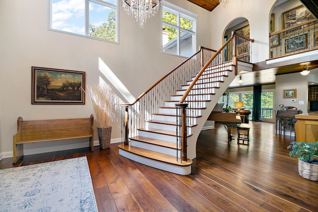 1444 Guildford Dr, Bourbonnais, IL 60914 - staircase featuring a towering ceiling, hardwood / wood-style floors, plenty of natural light, and a chandelier