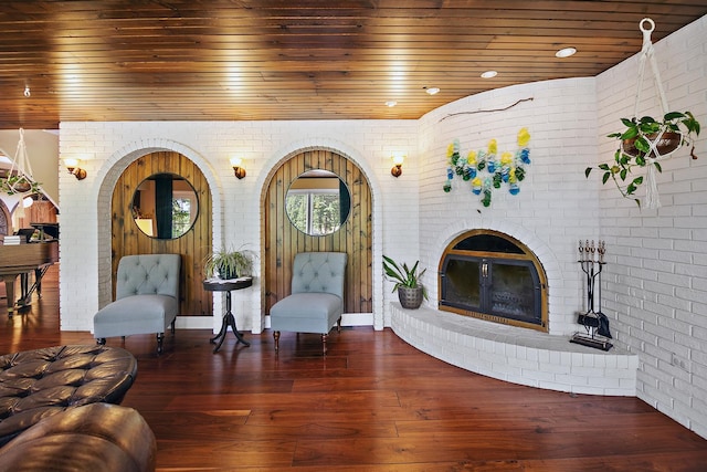 1444 Guildford Dr, Bourbonnais, IL 60914 - living room featuring brick wall, wood ceiling, a brick fireplace, and wood-type flooring