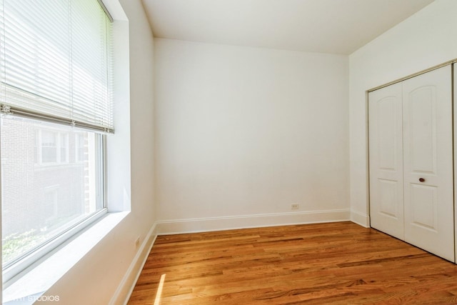 5412 N Kenmore Ave Unit 1W, Chicago, IL 60640 - unfurnished bedroom featuring light wood-style floors and a closet