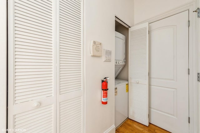 5412 N Kenmore Ave Unit 1W, Chicago, IL 60640 - laundry room with stacked washer and clothes dryer and light wood finished floors