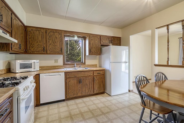 15229 Catalina Dr Unit 1D, Orland Park, IL 60462 - kitchen featuring white appliances, light flooring, light countertops, and brown cabinetry