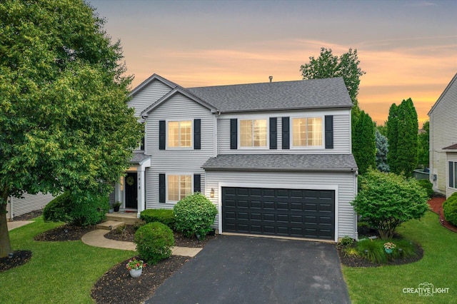 1918 Congrove Dr, Aurora, IL 60504 - traditional home featuring a garage, asphalt driveway, a front yard, and roof with shingles