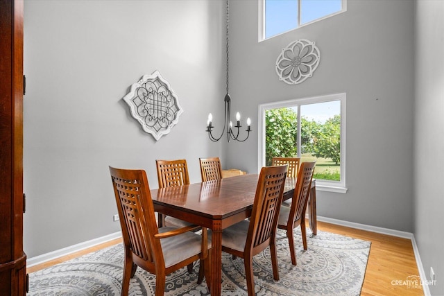1918 Congrove Dr, Aurora, IL 60504 - dining space with a chandelier, light wood-type flooring, and a towering ceiling