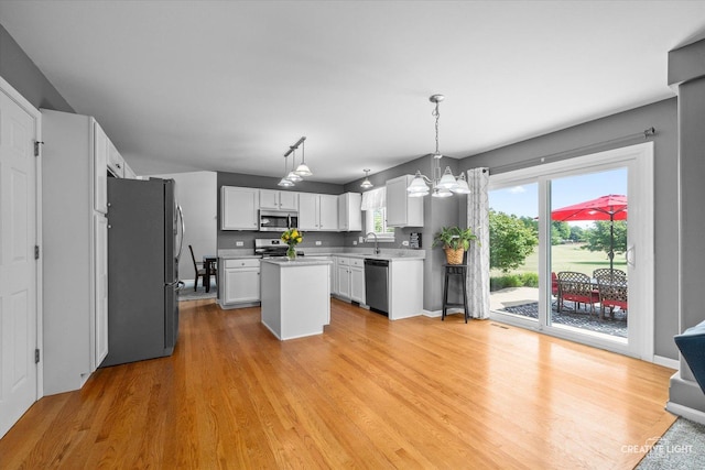 1918 Congrove Dr, Aurora, IL 60504 - kitchen featuring stainless steel appliances, light wood-style floors, light countertops, a center island, and a chandelier