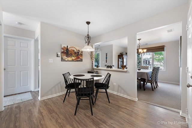 2109 Ammer Ridge Ct Unit 201, Glenview, IL 60025 - dining area featuring a chandelier and wood finished floors