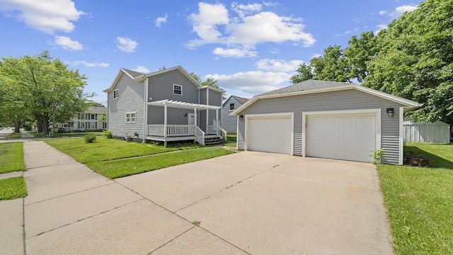 502 N Dixon Ave, Dixon, IL 61021 - traditional-style home featuring a pergola, an outdoor structure, a front yard, and a detached garage