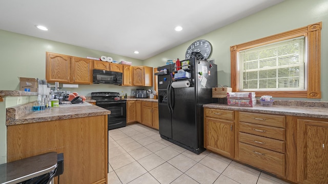 502 N Dixon Ave, Dixon, IL 61021 - kitchen with black appliances, light tile patterned floors, recessed lighting, and brown cabinetry