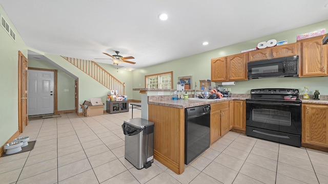502 N Dixon Ave, Dixon, IL 61021 - kitchen featuring black appliances, a peninsula, light tile patterned floors, light countertops, and recessed lighting