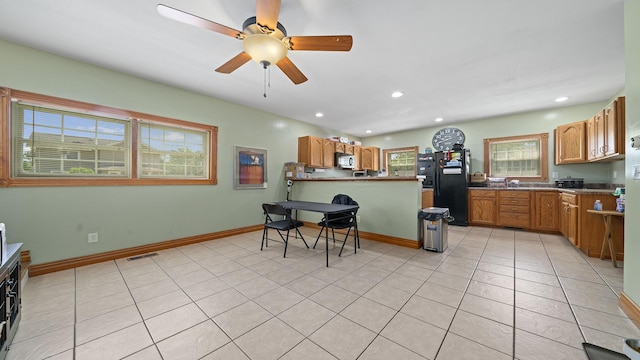 502 N Dixon Ave, Dixon, IL 61021 - kitchen featuring freestanding refrigerator, ceiling fan, light tile patterned floors, recessed lighting, and a peninsula