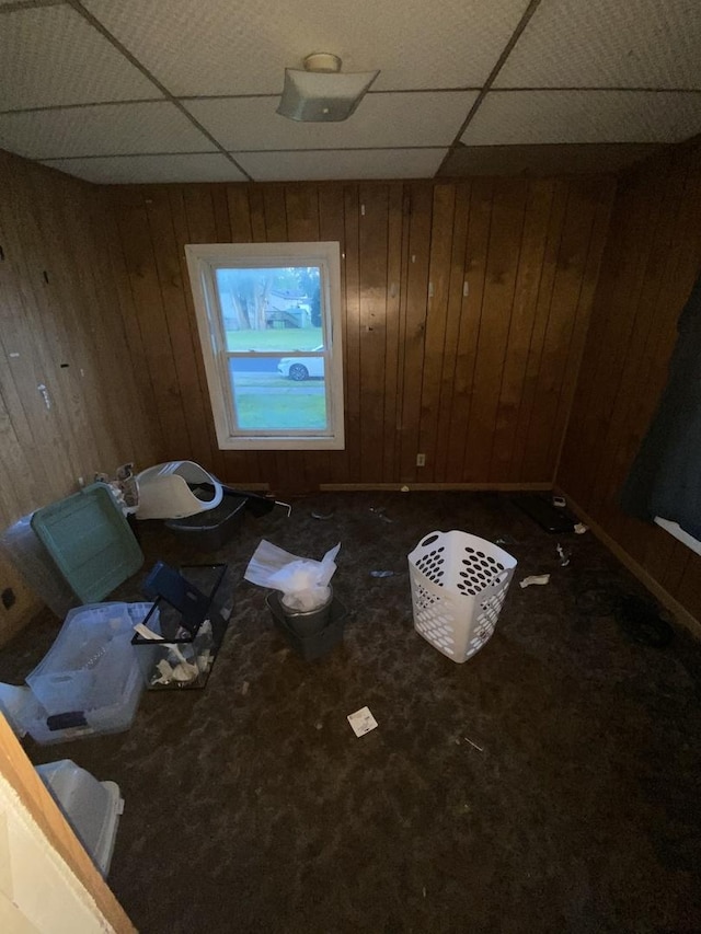 106 W Sheridan St, Watseka, IL 60970 - carpeted empty room with a paneled ceiling and wood walls
