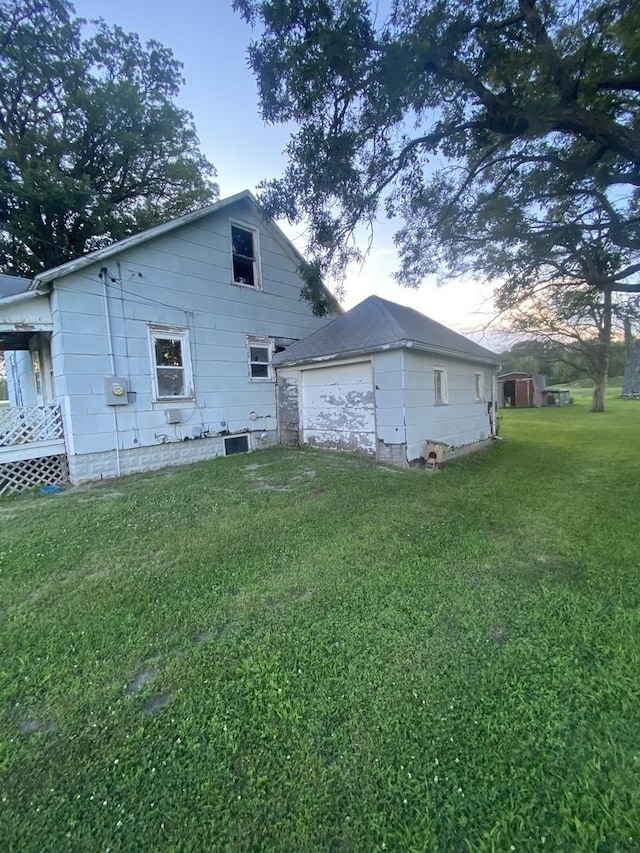 106 W Sheridan St, Watseka, IL 60970 - rear view of property with an outdoor structure, a lawn, and a garage