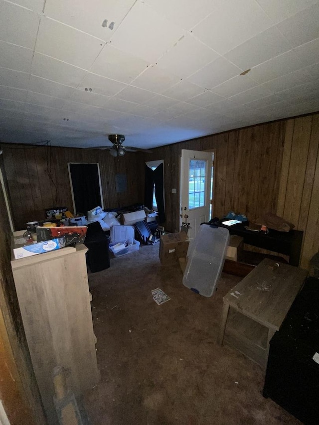 106 W Sheridan St, Watseka, IL 60970 - living area with wooden walls, ceiling fan, and a paneled ceiling