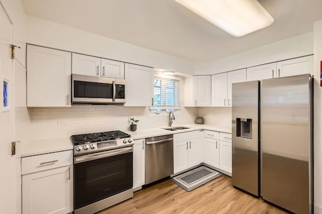437 S Elmhurst Rd, Mount Prospect, IL 60056 - kitchen featuring stainless steel appliances, white cabinets, light countertops, and tasteful backsplash