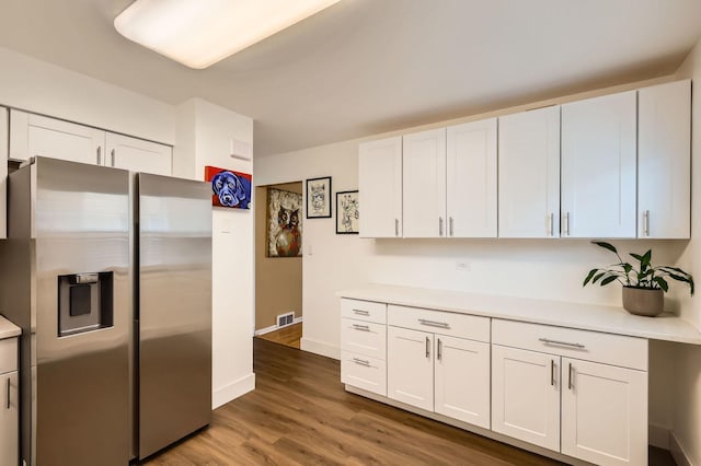 437 S Elmhurst Rd, Mount Prospect, IL 60056 - kitchen featuring stainless steel fridge, light countertops, white cabinetry, and dark wood-type flooring