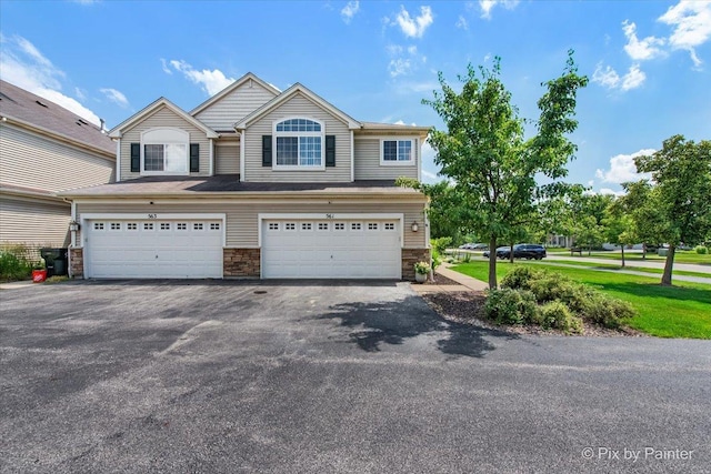 561 S Jade Ln Unit 1106, Round Lake, IL 60073 - view of front of property featuring an attached garage, driveway, and stone siding