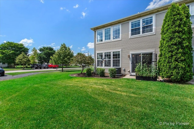 561 S Jade Ln Unit 1106, Round Lake, IL 60073 - rear view of property featuring a yard