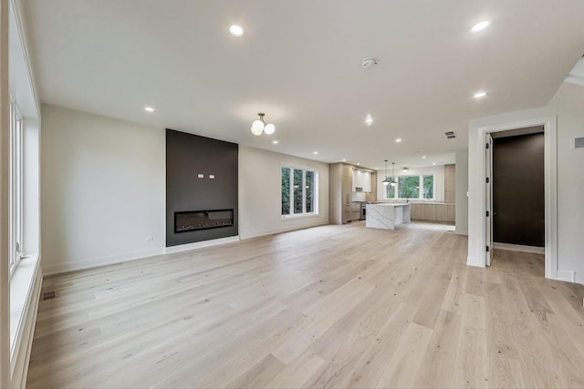 5830 Brookbank Rd, Downers Grove, IL 60516 - unfurnished living room featuring light wood-style flooring, a large fireplace, and recessed lighting