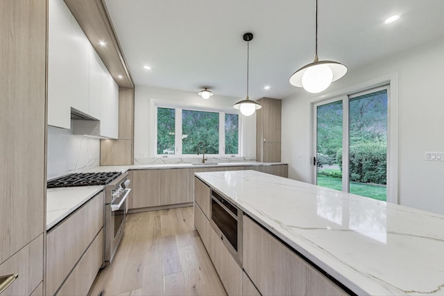 5830 Brookbank Rd, Downers Grove, IL 60516 - kitchen featuring modern cabinets, high end stainless steel range oven, light stone counters, light wood-type flooring, and recessed lighting