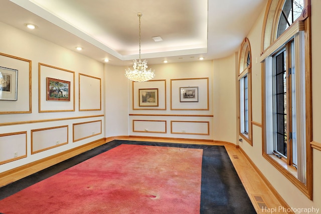 74 Dundee Ln, Barrington Hills, IL 60010 - spare room with a chandelier, a raised ceiling, and recessed lighting