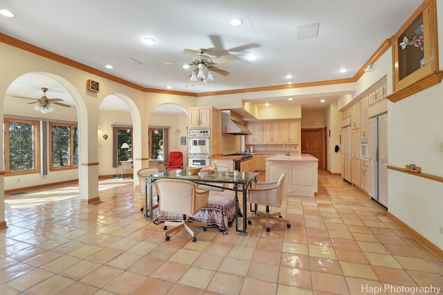 74 Dundee Ln, Barrington Hills, IL 60010 - dining room featuring a ceiling fan, crown molding, arched walkways, recessed lighting, and light tile patterned floors
