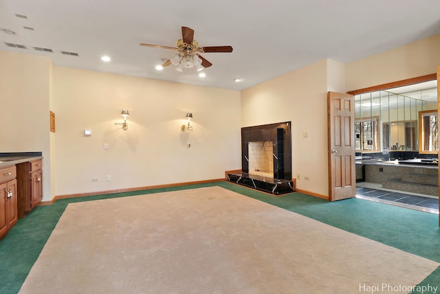 74 Dundee Ln, Barrington Hills, IL 60010 - unfurnished living room with dark colored carpet, ceiling fan, recessed lighting, and a tile fireplace