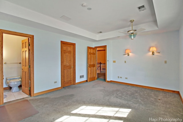 74 Dundee Ln, Barrington Hills, IL 60010 - unfurnished bedroom featuring carpet flooring, a tray ceiling, and ensuite bathroom