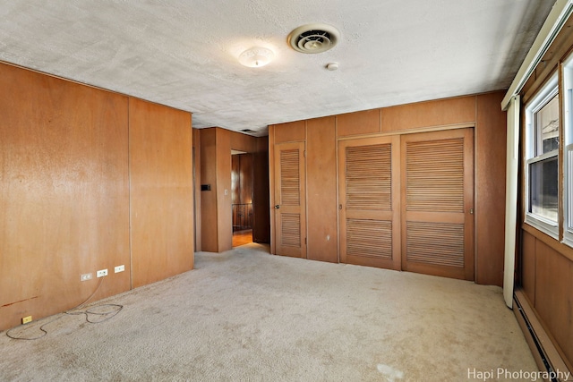 74 Dundee Ln, Barrington Hills, IL 60010 - unfurnished bedroom with baseboard heating, carpet, two closets, and a textured ceiling