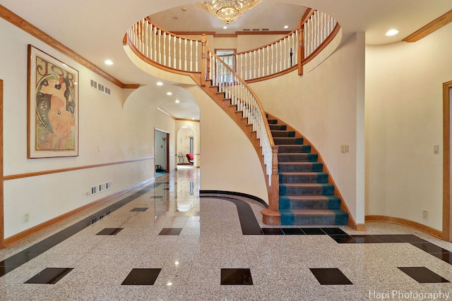 74 Dundee Ln, Barrington Hills, IL 60010 - staircase with granite tiled floors, arched walkways, ornamental molding, a high ceiling, and recessed lighting