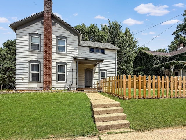 821 W Douglas St, Freeport, IL 61032 - view of front facade featuring a chimney