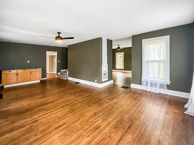 821 W Douglas St, Freeport, IL 61032 - unfurnished living room featuring ceiling fan and wood finished floors