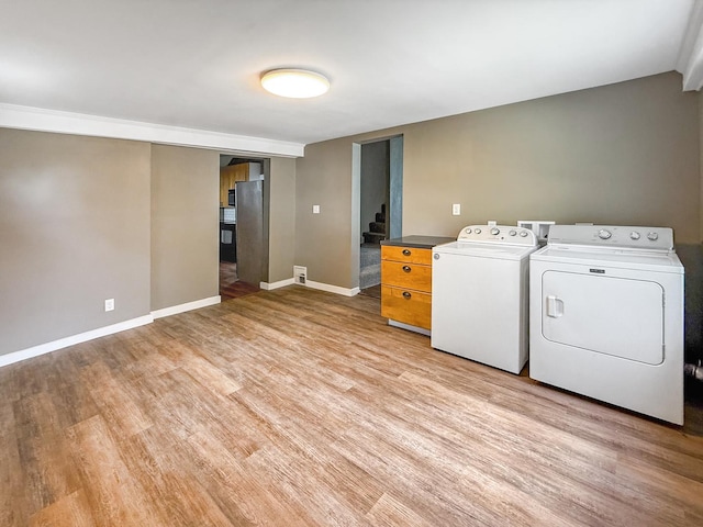 821 W Douglas St, Freeport, IL 61032 - laundry room featuring washer and dryer and light wood-style flooring