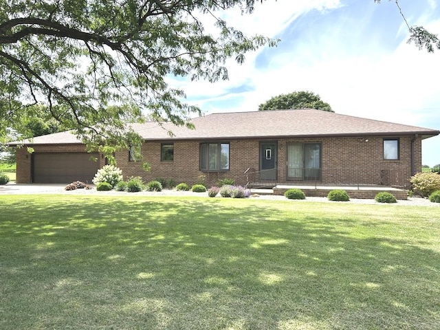 70 N Main St, Lamoille, IL 61330 - ranch-style home featuring a garage, a front lawn, brick siding, and driveway