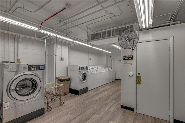 1450 E 55th Pl Unit 630S, Chicago, IL 60637 - communal laundry room with washing machine and dryer and wood finished floors