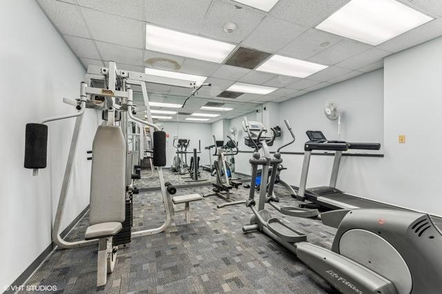 1450 E 55th Pl Unit 630S, Chicago, IL 60637 - gym with a paneled ceiling and carpet floors