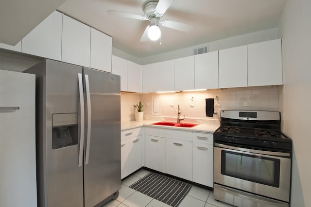 1450 E 55th Pl Unit 630S, Chicago, IL 60637 - kitchen featuring appliances with stainless steel finishes, light countertops, decorative backsplash, white cabinetry, and light tile patterned floors