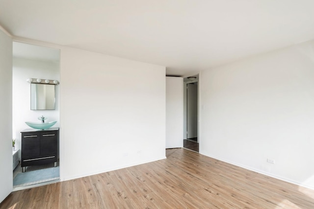 1450 E 55th Pl Unit 630S, Chicago, IL 60637 - empty room with wood finished floors and a sink