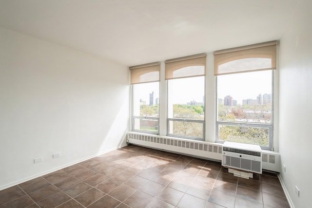1450 E 55th Pl Unit 630S, Chicago, IL 60637 - unfurnished room featuring radiator, a city view, and tile patterned floors