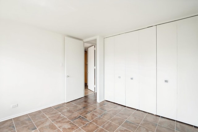 1450 E 55th Pl Unit 630S, Chicago, IL 60637 - unfurnished bedroom with a closet and light tile patterned floors