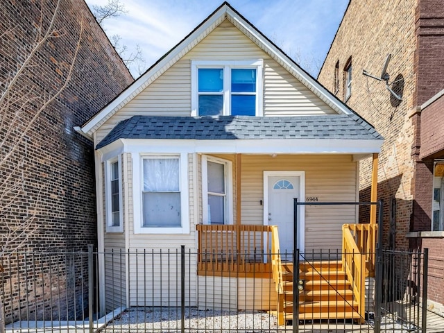 6944 S Racine Ave, Chicago, IL 60636 - bungalow featuring a shingled roof, a fenced front yard, covered porch, and a gate