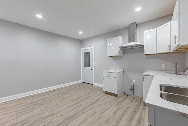 6944 S Racine Ave, Chicago, IL 60636 - kitchen with wall chimney exhaust hood, light stone counters, light wood-style flooring, white cabinets, and recessed lighting