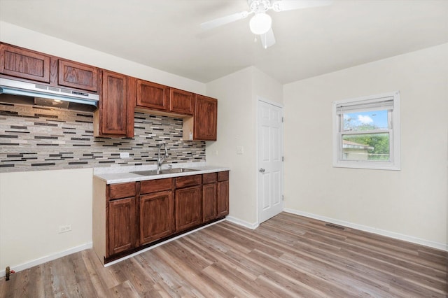 2133 Luther Ave, Lockport, IL 60441 - kitchen featuring under cabinet range hood, light wood-style flooring, backsplash, light countertops, and ceiling fan