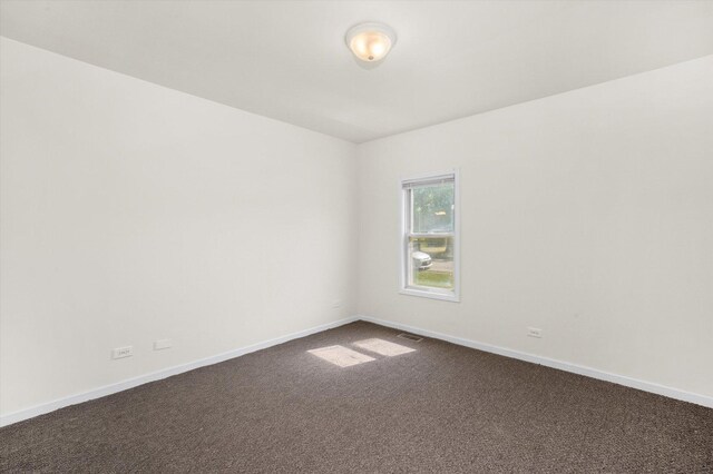 2133 Luther Ave, Lockport, IL 60441 - empty room featuring dark colored carpet and baseboards