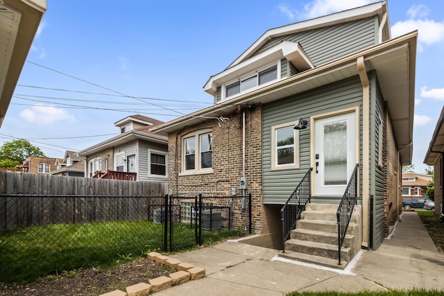 8114 S Paxton Ave, Chicago, IL 60617 - bungalow-style home featuring entry steps, brick siding, and a gate