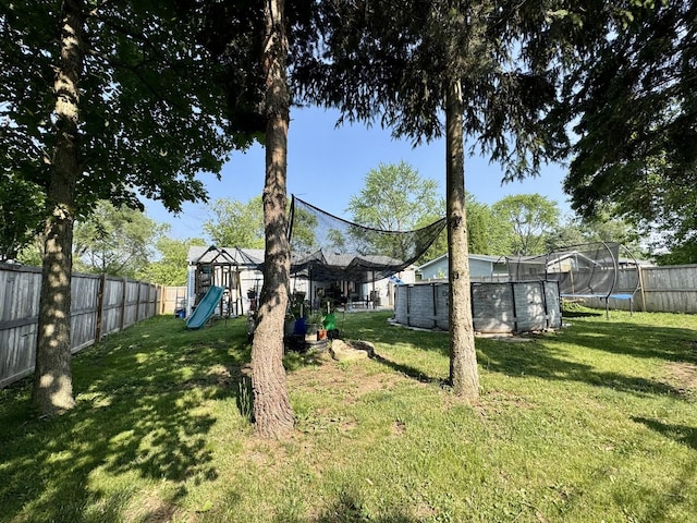 311 Edinburgh Dr, Lockport, IL 60441 - fenced backyard featuring a trampoline, a playground, and a swimming pool
