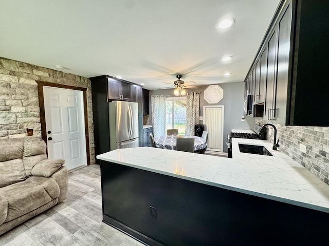 311 Edinburgh Dr, Lockport, IL 60441 - kitchen featuring freestanding refrigerator, white gas stove, a peninsula, ceiling fan, and open floor plan