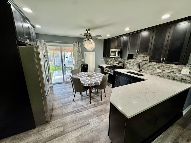 311 Edinburgh Dr, Lockport, IL 60441 - kitchen featuring appliances with stainless steel finishes, backsplash, recessed lighting, a ceiling fan, and light wood finished floors