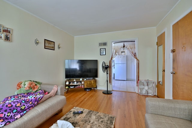 living room featuring wood finished floors and ornamental molding